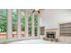 Bright living room featuring a stone fireplace, built-in shelving, and large windows with a backyard view at 2688 Hidden Falls Ne Dr, Buford, GA 30519