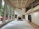 Spacious living room with built-in bookshelves, large windows and stone fireplace at 2688 Hidden Falls Ne Dr, Buford, GA 30519