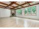 Large living area with stone fireplace, beamed ceiling, hardwood floors and ample natural light at 2688 Hidden Falls Ne Dr, Buford, GA 30519