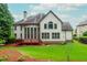 Back of house with a deck, tall windows, and a well-maintained lawn and landscaping at 2688 Hidden Falls Ne Dr, Buford, GA 30519