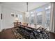 Dining room with large windows, modern lighting, and seating for eight guests at 3208 Sonnet Se Walk, Atlanta, GA 30339