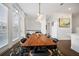 Dining room with large windows, modern lighting, and seating for eight guests at 3208 Sonnet Se Walk, Atlanta, GA 30339
