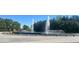View of a tranquil fountain surrounded by lush greenery and trees, creating a peaceful outdoor oasis at 3208 Sonnet Se Walk, Atlanta, GA 30339