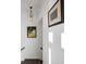 Hallway features modern lighting, crisp white walls, beautiful artwork and hardwood flooring at 3208 Sonnet Se Walk, Atlanta, GA 30339
