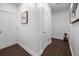 Hallway with hardwood floors and white walls, complemented by framed wall decor at 3208 Sonnet Se Walk, Atlanta, GA 30339