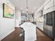 Sleek kitchen featuring a long island, stainless steel appliances, and modern white cabinetry at 3208 Sonnet Se Walk, Atlanta, GA 30339
