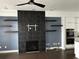 Inviting living room with a black tile fireplace, floating shelves, and modern ceiling fan at 3208 Sonnet Se Walk, Atlanta, GA 30339