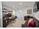 A well-lit office space featuring a desk, sofa, and shelves filled with books, bathed in natural light at 3208 Sonnet Se Walk, Atlanta, GA 30339