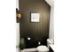Modern powder room features unique wallpaper, framed artwork, and a sleek toilet at 3208 Sonnet Se Walk, Atlanta, GA 30339