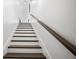 Staircase with hardwood treads, white risers, and a stained handrail at 3208 Sonnet Se Walk, Atlanta, GA 30339