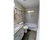 Modern bathroom with granite countertop, tiled walls, hexagon floor tile, and shower-tub combo at 3954 Rhyne Se Way, Smyrna, GA 30082