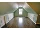 Large bedroom with sloped ceilings, hardwood floors, and built-in storage at 3954 Rhyne Se Way, Smyrna, GA 30082