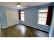 Bedroom with blue walls, hardwood floors, a ceiling fan, two windows and a closet at 3954 Rhyne Se Way, Smyrna, GA 30082