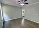 Bedroom featuring hardwood floors, ceiling fan, and a doorway leading to an ensuite bathroom at 3954 Rhyne Se Way, Smyrna, GA 30082