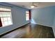 Bright bedroom with light blue walls, hardwood floors, and a ceiling fan with views from the large windows at 3954 Rhyne Se Way, Smyrna, GA 30082