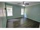 Bright bedroom with light green walls, hardwood floors, ceiling fan and good natural light at 3954 Rhyne Se Way, Smyrna, GA 30082