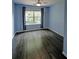 A stylish bedroom with hardwood floors, large window, and light blue walls at 3954 Rhyne Se Way, Smyrna, GA 30082