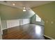 Spacious bedroom with sloped ceilings, hardwood floors, and white storage doors at 3954 Rhyne Se Way, Smyrna, GA 30082