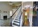Inviting entryway with staircase leading to a bright, open living area with a fireplace at 3954 Rhyne Se Way, Smyrna, GA 30082