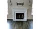 Elegant white fireplace with marble hearth and mantle flanked by windows for natural light at 3954 Rhyne Se Way, Smyrna, GA 30082
