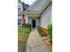 Inviting entryway of a home with a black front door, American flag, and well-maintained landscaping at 3954 Rhyne Se Way, Smyrna, GA 30082