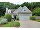 Well-maintained home with a two-car garage, complemented by lush landscaping and a green lawn at 3954 Rhyne Se Way, Smyrna, GA 30082