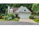 Traditional home with neutral siding, attached garage, green lawn and tree lined property at 3954 Rhyne Se Way, Smyrna, GA 30082