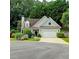 Charming front exterior featuring a two-car garage, well-maintained landscaping, and a welcoming entrance at 3954 Rhyne Se Way, Smyrna, GA 30082