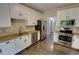 Modern kitchen boasts stainless steel appliances, white cabinetry, and stone backsplash at 3954 Rhyne Se Way, Smyrna, GA 30082