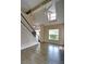 Spacious living room featuring high ceilings, fan, large windows, and hardwood floors at 3954 Rhyne Se Way, Smyrna, GA 30082