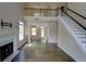 Open-concept living room with hardwood floors, fireplace, staircase and soaring ceilings at 3954 Rhyne Se Way, Smyrna, GA 30082