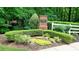 Paces Springs community entrance with brick signage, white fence and manicured landscaping at 3954 Rhyne Se Way, Smyrna, GA 30082