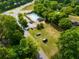 Aerial view showcasing community pool and open space, surrounded by mature trees and lush greenery at 5223 Willow Ridge Dr, Woodstock, GA 30188