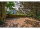 View of the backyard with a wooden fence and glimpses of the house at 5223 Willow Ridge Dr, Woodstock, GA 30188