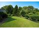 Expansive backyard featuring a lush lawn and mature landscaping at 5223 Willow Ridge Dr, Woodstock, GA 30188
