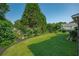 A well-manicured backyard featuring a sprawling lawn with garden beds at 5223 Willow Ridge Dr, Woodstock, GA 30188