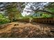 The backyard of the home features a wooden fence and multiple trees at 5223 Willow Ridge Dr, Woodstock, GA 30188