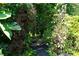 Stone pathway framed by a lush garden featuring mature trees and foliage at 5223 Willow Ridge Dr, Woodstock, GA 30188