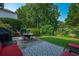 Landscaped backyard with mature trees, a patio, and a well-maintained lawn at 5223 Willow Ridge Dr, Woodstock, GA 30188
