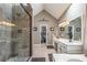 Bright bathroom featuring double sink, walk-in shower with tile surround, and doorway to walk-in closet at 5223 Willow Ridge Dr, Woodstock, GA 30188