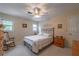 Bedroom featuring a ceiling fan, wood dresser, rocking chair, and full sized bed at 5223 Willow Ridge Dr, Woodstock, GA 30188