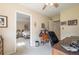 Bedroom with a peek into the bed, with desk and chair in the foreground at 5223 Willow Ridge Dr, Woodstock, GA 30188