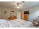 Bedroom featuring a ceiling fan, wood dresser, mirror, and full sized bed at 5223 Willow Ridge Dr, Woodstock, GA 30188