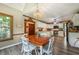 Eat-in kitchen with white chairs, wood table, and bright windows at 5223 Willow Ridge Dr, Woodstock, GA 30188
