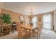 Formal dining room with chandelier, large table, and elegant decor at 5223 Willow Ridge Dr, Woodstock, GA 30188