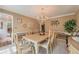 Elegant dining room with a chandelier, wainscoting, and ample seating at 5223 Willow Ridge Dr, Woodstock, GA 30188