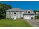 Two-story home featuring a manicured lawn, a two-car garage, and a classic gray facade with white trim at 5223 Willow Ridge Dr, Woodstock, GA 30188