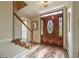 Inviting foyer featuring a grand wooden door with glass inserts and views of the staircase at 5223 Willow Ridge Dr, Woodstock, GA 30188