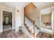 Bright foyer featuring hardwood floors, a staircase with white risers, and an open doorway to adjacent rooms at 5223 Willow Ridge Dr, Woodstock, GA 30188