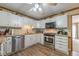 Modern kitchen with white cabinets, stainless steel appliances, and hardwood floors at 5223 Willow Ridge Dr, Woodstock, GA 30188